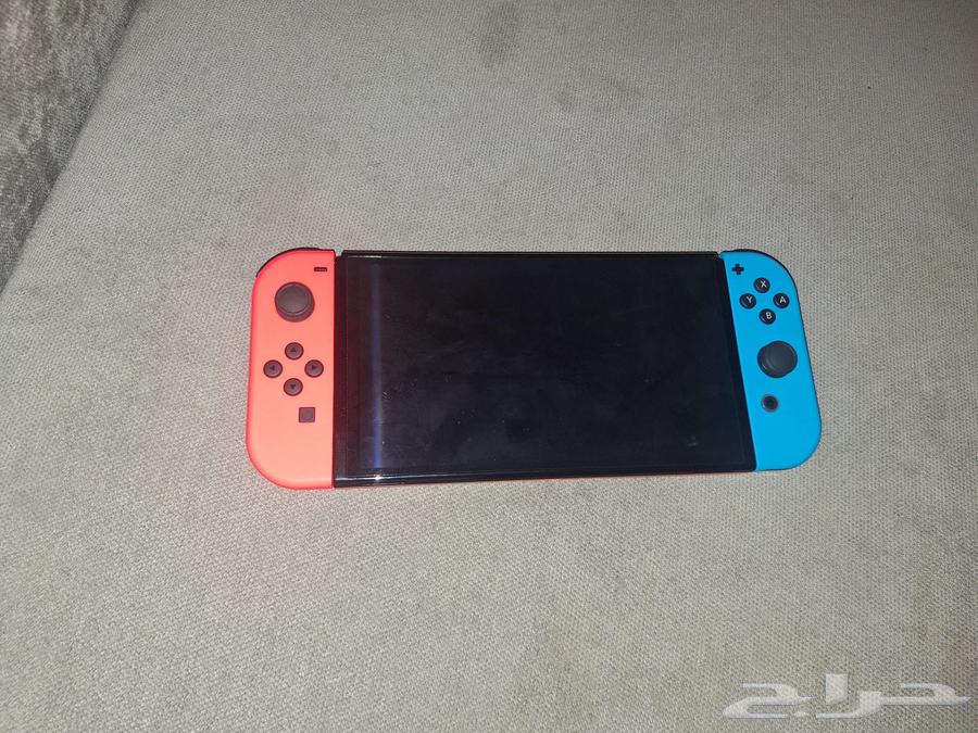 Nintendo Switch with two hands and four game cards used63097483344258111