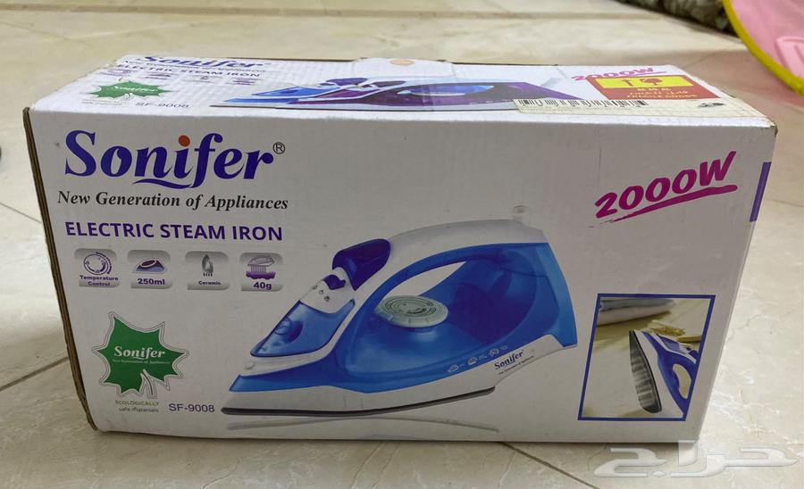 A new, unused handheld steam iron in its carton.63407539557378111