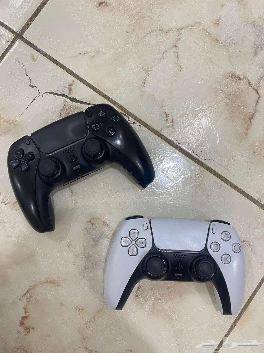 Two Sony 5 controllers, one white and one black, contact via WhatsApp64455290924929114