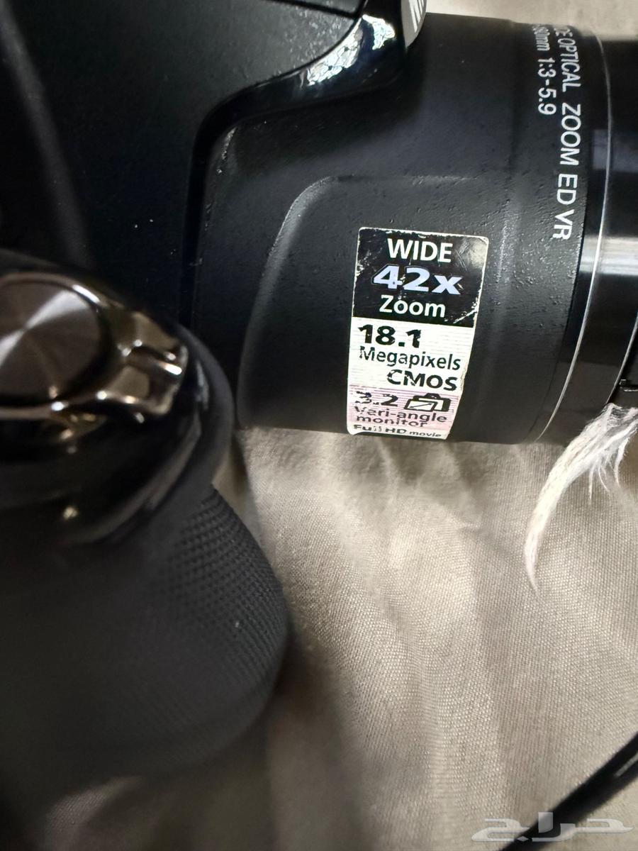 The camera shown in the image is a Nikon Coolpix64520572010371112