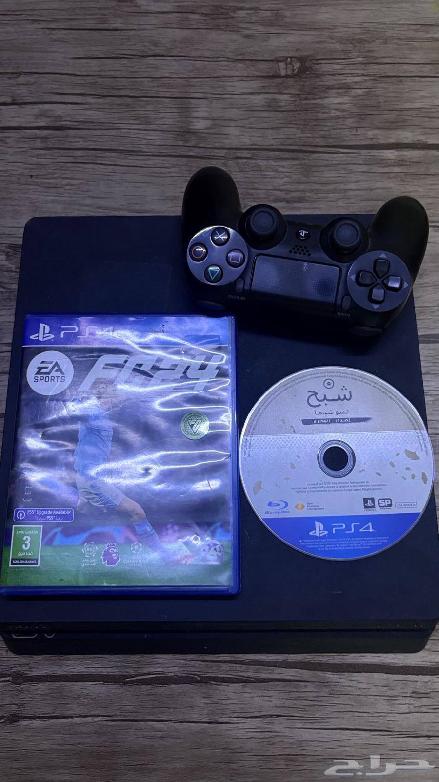 Sony 4 with controller and FIFA 24, 20, and Ghost of Tsushima tapes64570066966786111